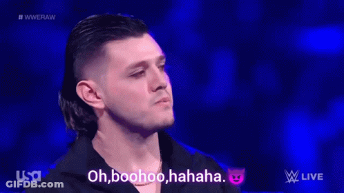 A Group Of Wrestlers Are Standing In A Wrestling Ring And One Of Them Says Oh Boohoo Haha GIF