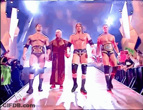A Group Of Wrestlers Are Walking Down A Ramp Holding Hands GIF