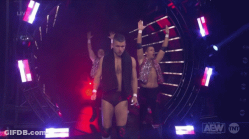 A Group Of Wrestlers On A Stage With Aew Written On The Bottom Right GIF