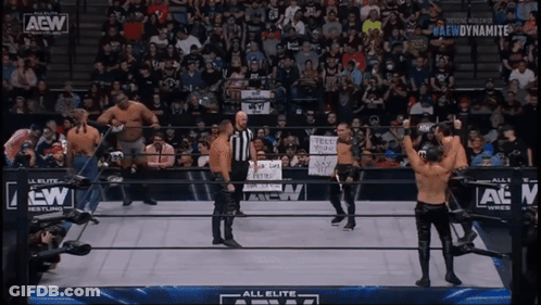 A Group Of Wrestlers Standing In A Ring With A Aew Logo GIF