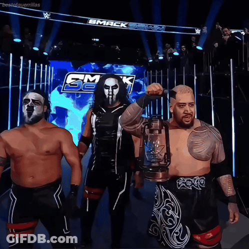 A Group Of Wrestlers Standing In Front Of A Sign That Says Smack Down GIF