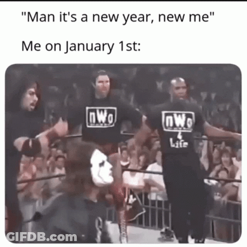 A Group Of Wrestlers Wearing Nwo Shirts Are Standing In A Wrestling Ring GIF