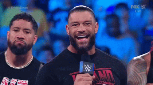 A Group Of Wrestlers Wearing Shirts That Say We The Ones Stand In A Wrestling Ring GIF