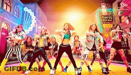 A Group Of Young Girls Are Dancing In Front Of A Perfume Bottle That Says Angel G GIF