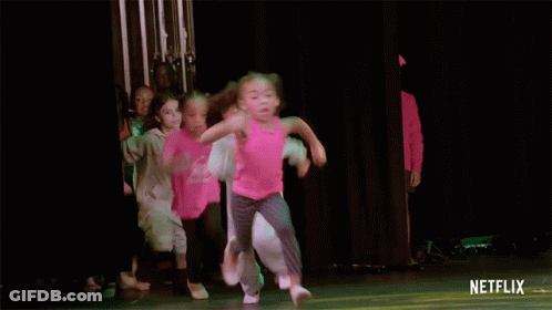 A Group Of Young Girls Are Dancing On A Stage With A Netflix Logo On The Bottom GIF