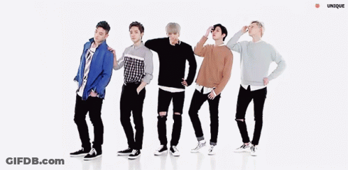 A Group Of Young Men Are Dancing In A Line With Their Arms Outstretched . GIF