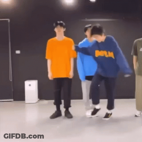 A Group Of Young Men Are Dancing In A Room . GIF