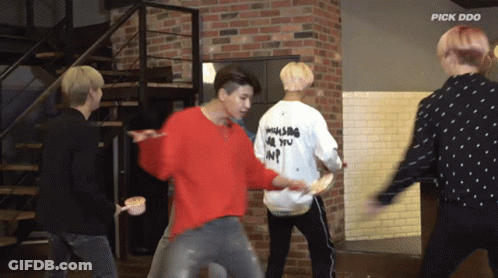 A Group Of Young Men Are Dancing In Front Of A Brick Wall And The Words Pick Doo Are On The Bottom GIF