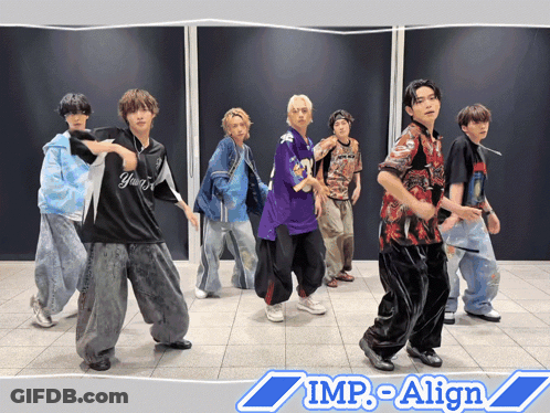 A Group Of Young Men Are Dancing In Front Of A Wall That Says Imp-Align On It GIF