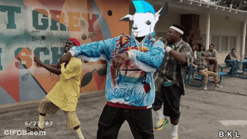 Young Men Dancing In Front Of T Grey Wall GIF