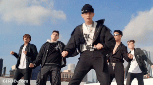 A Group Of Young Men Are Dancing On A Rooftop In Front Of A City Skyline GIF