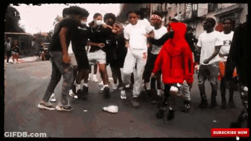 A Group Of Young Men Are Dancing On A Street With A Subscribe Now Button On The Bottom GIF