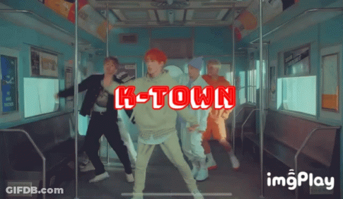 A Group Of Young Men Are Dancing On A Train And The Words K-Town Are Displayed GIF