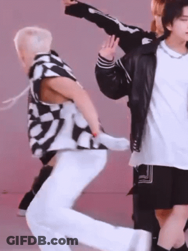 A Group Of Young Men Are Dancing Together And One Of Them Is Wearing A Skeleton Jacket GIF
