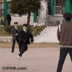A Group Of Young Men Are Playing A Game Of Soccer On A Field . GIF