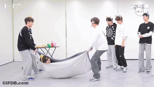 A Group Of Young Men Are Playing A Game With A Blanket That Says Hype GIF