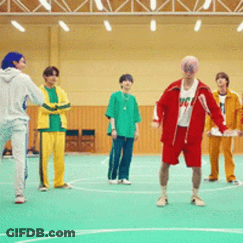 A Group Of Young Men Are Playing Basketball In A Gym And One Of Them Is Wearing A Shirt That Says Mc GIF