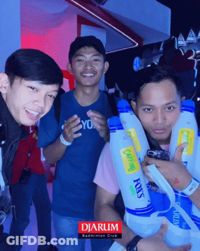 A Group Of Young Men Are Posing For A Photo With A Sign That Says Djarum GIF