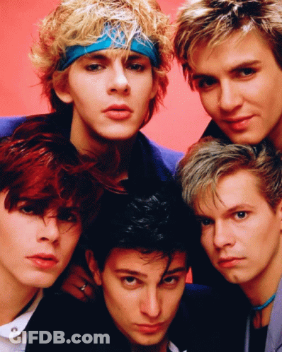 A Group Of Young Men Are Posing For A Picture And One Has A Blue Headband On GIF