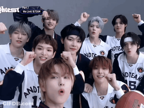 A Group Of Young Men Are Posing For A Picture And One Of Them Has The Number 1 On His Shirt GIF
