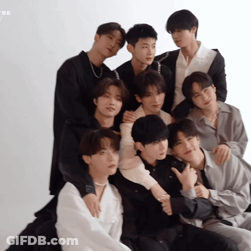 A Group Of Young Men Are Posing For A Picture And One Of Them Is Giving The Thumbs Up Sign GIF