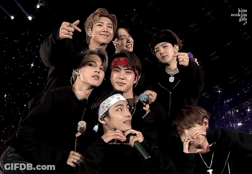 A Group Of Young Men Are Posing For A Picture And One Of Them Is Wearing A Bandana GIF