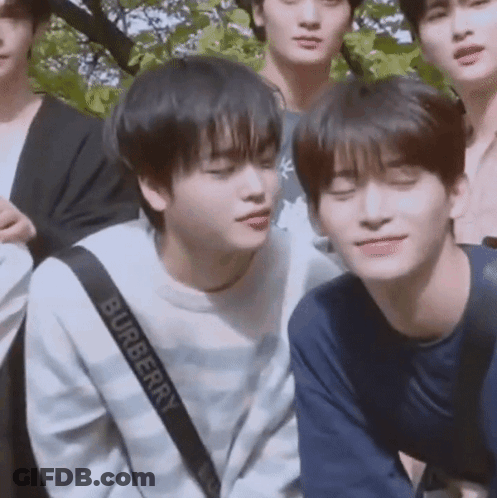 A Group Of Young Men Are Posing For A Picture And One Of Them Is Wearing A Burberry Sweatshirt . GIF