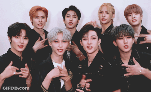 A Group Of Young Men Are Posing For A Picture And One Of Them Is Wearing A Necklace With The Letter G On It GIF