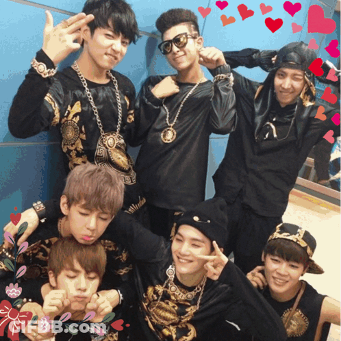 A Group Of Young Men Are Posing For A Picture And One Of Them Is Wearing A Shirt That Says Versace GIF