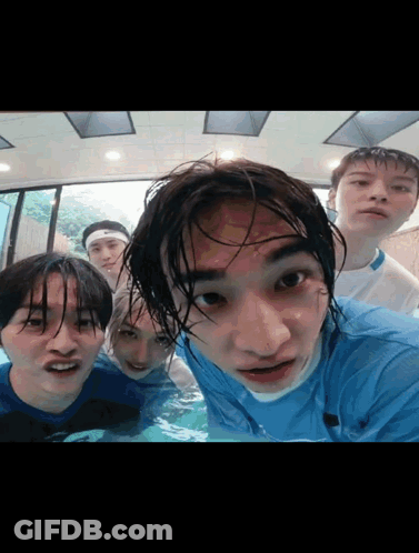 A Group Of Young Men Are Posing For A Picture In The Water GIF