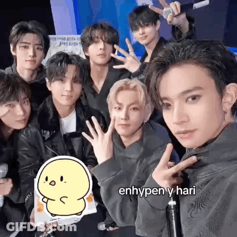 A Group Of Young Men Are Posing For A Picture Together While Holding Microphones . GIF
