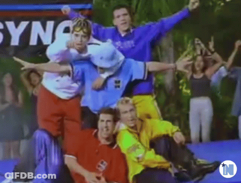 A Group Of Young Men Are Posing For A Picture While Sitting On A Trampoline . GIF