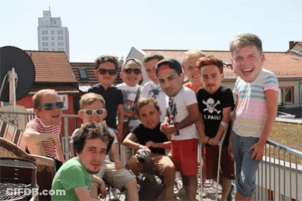 A Group Of Young Men Are Posing For A Picture With One Wearing A Shirt That Says Pauli GIF