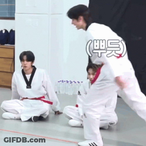 A Group Of Young Men Are Practicing Martial Arts And One Of Them Is Wearing A White Adidas Shirt GIF
