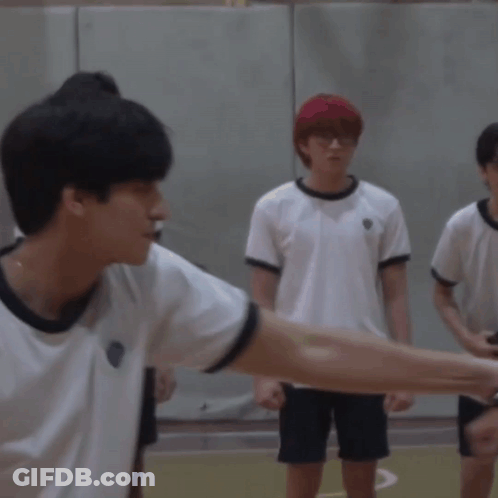 A Group Of Young Men Are Shaking Hands On A Court GIF