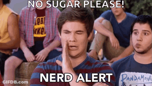 A Group Of Young Men Are Sitting Around A Table And One Of Them Is Wearing A Pandamovie Shirt GIF