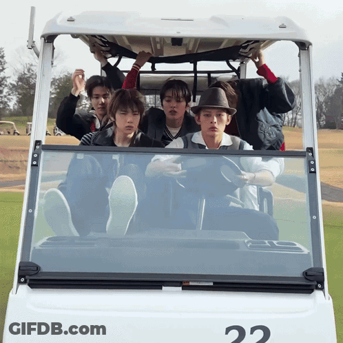A Group Of Young Men Are Sitting In A Golf Cart With The Number 22 On It GIF