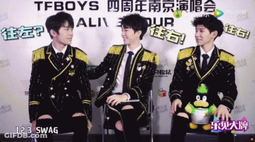 A Group Of Young Men Are Sitting In Front Of A Sign That Says Tfboys On It GIF