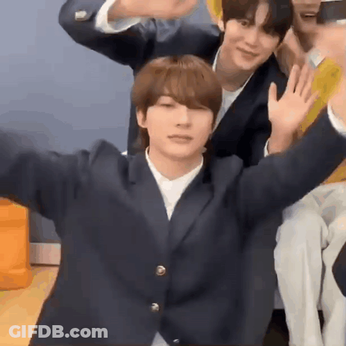Young Men Sitting And Waving GIF