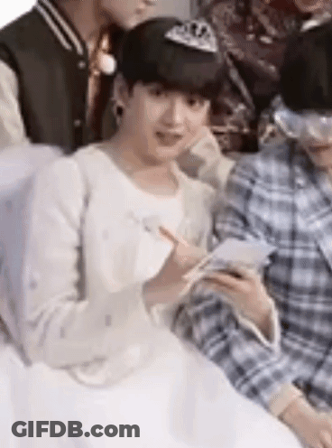 A Group Of Young Men Are Sitting Next To Each Other . GIF