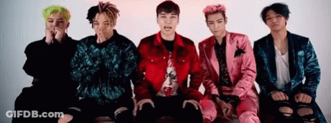 A Group Of Young Men Are Sitting Next To Each Other On A Couch . GIF