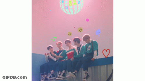 Young Men Sitting On Wall In Front Of Disco Ball GIF