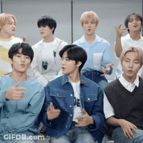 A Group Of Young Men Are Sitting Together And One Of Them Is Wearing A Shirt That Says ' E ' GIF