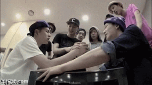Young Men Holding Hands Around Table GIF