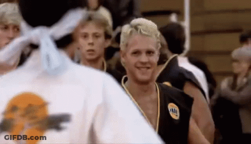 A Group Of Young Men Are Standing In A Gym . GIF