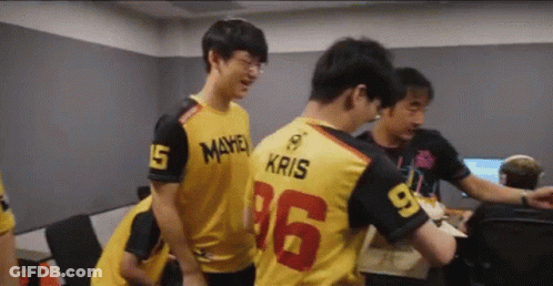 A Group Of Young Men Are Standing In A Room And One Of Them Is Wearing A Jersey With The Number 16 On It . GIF