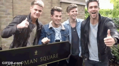 A Group Of Young Men Are Standing In Chapman Square Giving A Thumbs Up GIF