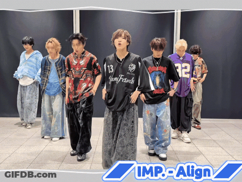 A Group Of Young Men Are Standing In Front Of A Wall With The Words Imp-Align On The Bottom Right GIF
