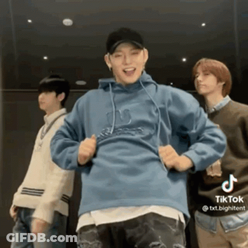 A Group Of Young Men Are Standing Next To Each Other And Dancing In A Room . GIF