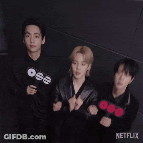 A Group Of Young Men Are Standing Next To Each Other And Holding Signs . GIF